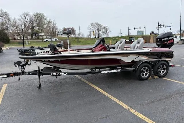 The Image of 2016 Nitro Z20 boat on trailer in parking lot, featuring sleek design and dual seats. - 0