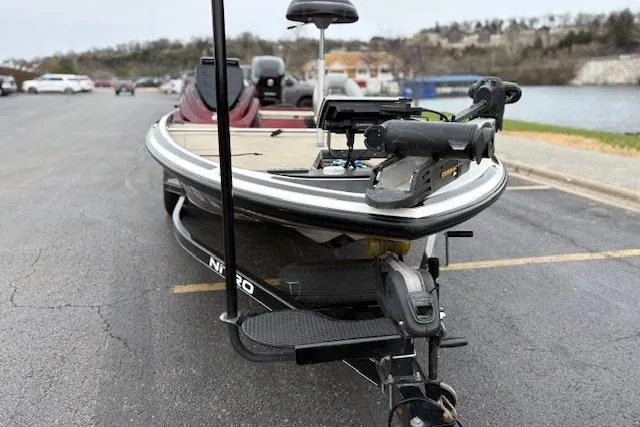 Slide: The Image of 2016 Nitro Z20 fishing boat on trailer in parking lot near water. - 13