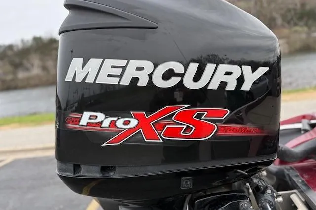 Slide: The Image of Mercury Pro XS outboard motor on 2016 Nitro Z20 boat, parked near a river. - 14