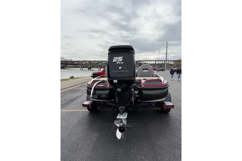 Slide: The Image of 2016 Nitro Z20 boat with 25 Pro engine, parked near a waterfront. - 16