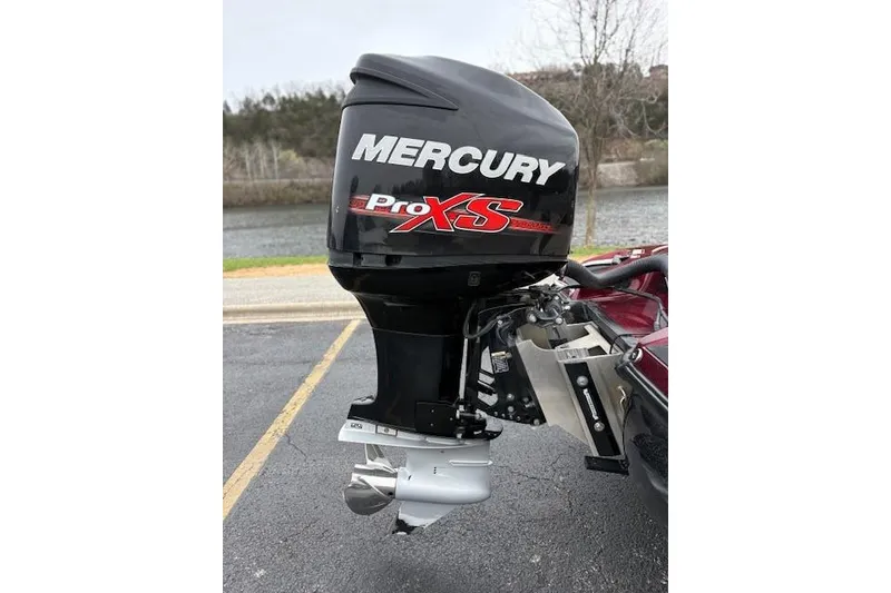Slide: The Image of Mercury Pro XS outboard motor on a 2016 Nitro Z20 boat, parked near a lake. - 21