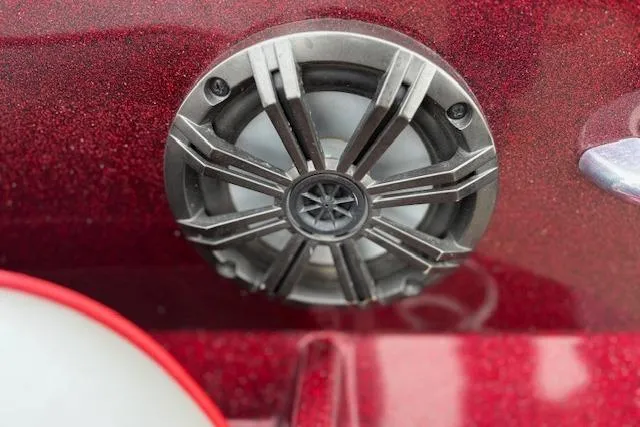 Slide: The Image of Close-up of a speaker on a 2016 Nitro Z20 boat, red metallic finish. - 23