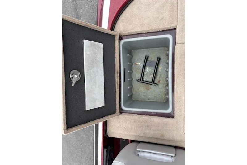 Slide: The Image of Open storage compartment in a 2016 Nitro Z20 boat with key and latch visible. - 25