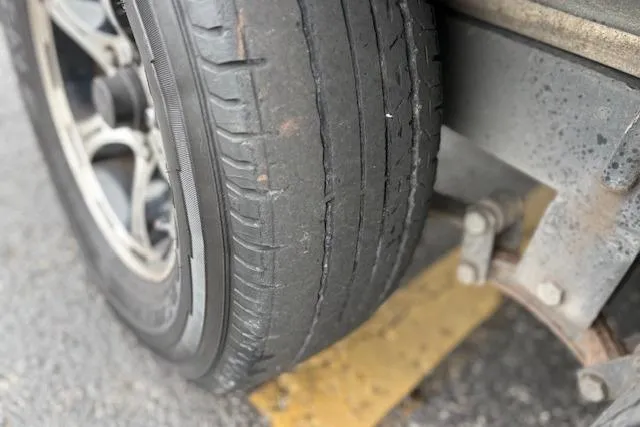 Slide: The Image of Worn tire on a 2016 Nitro Z20 vehicle, showing significant tread wear and damage. - 27