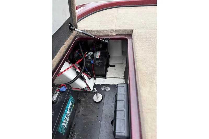 Slide: The Image of 2016 Nitro Z20 boat battery compartment with wiring and storage. - 33