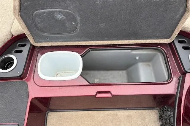 Slide: The Image of Open storage compartment in a 2016 Nitro Z20 boat, featuring cup holders and a cooler. - 36