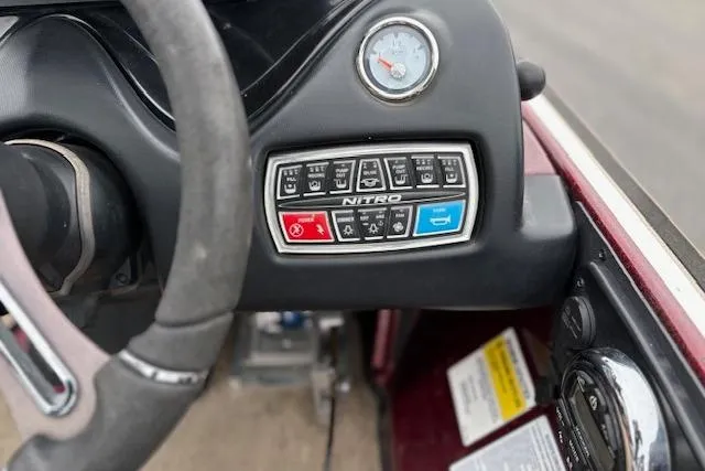 Slide: The Image of Steering wheel and control panel of a 2016 Nitro Z20 boat. - 38