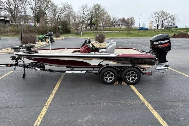 Slide: The Image of 2016 Nitro Z20 boat with Mercury Pro XS engine in a parking lot. - 4