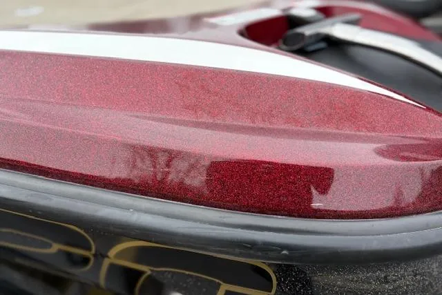 Slide: The Image of Close-up of a 2016 Nitro Z20 boat with a glossy red finish. - 46
