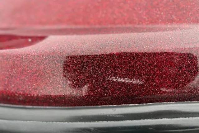 Slide: The Image of Close-up of a red metallic paint finish on a 2016 Nitro Z20 vehicle. - 48