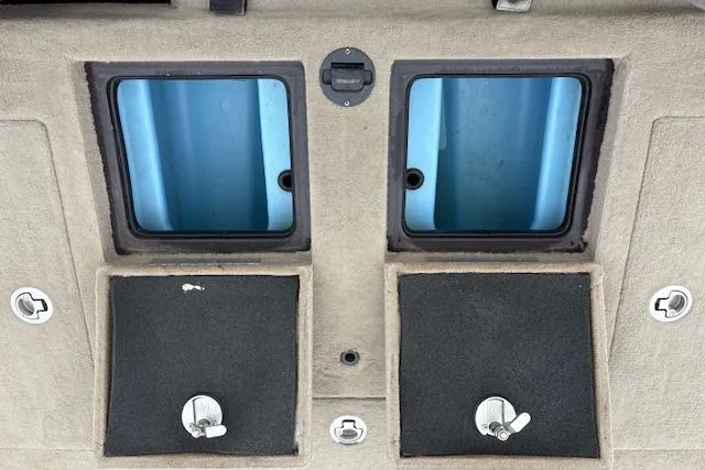 Slide: The Image of 2016 Nitro Z20 boat storage compartments with blue interiors and secure latches. - 55