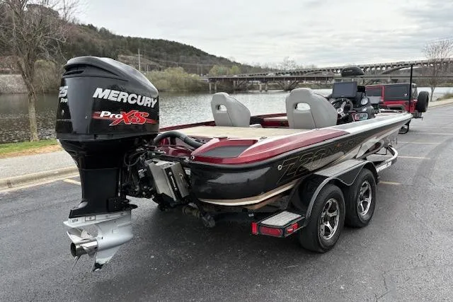 Slide: The Image of 2016 Nitro Z20 boat with Mercury Pro XS engine on trailer by river. - 7