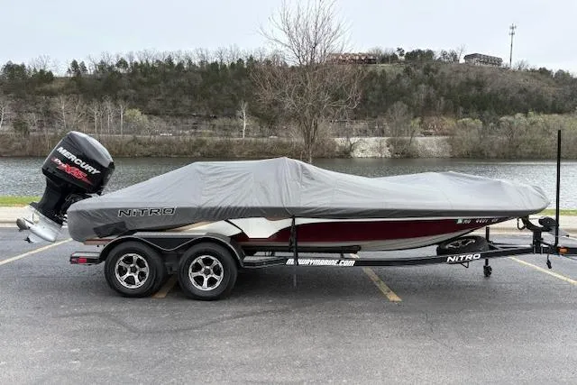 Slide: The Image of 2016 Nitro Z20 boat with cover, parked by a scenic riverside. - 8