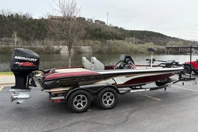 Slide: The Image of 2016 Nitro Z20 boat with Mercury Pro XS engine parked by a riverside. - 9