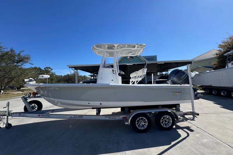 The Image of 2023 Sea Hunt BX 22 BR boat on trailer, parked outdoors under clear sky. - 1