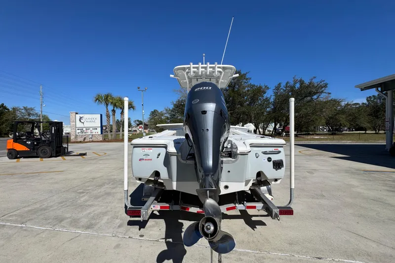 Slide: The Image of 2023 Sea Hunt BX 22 BR boat with powerful outboard motor, parked outdoors. - 14