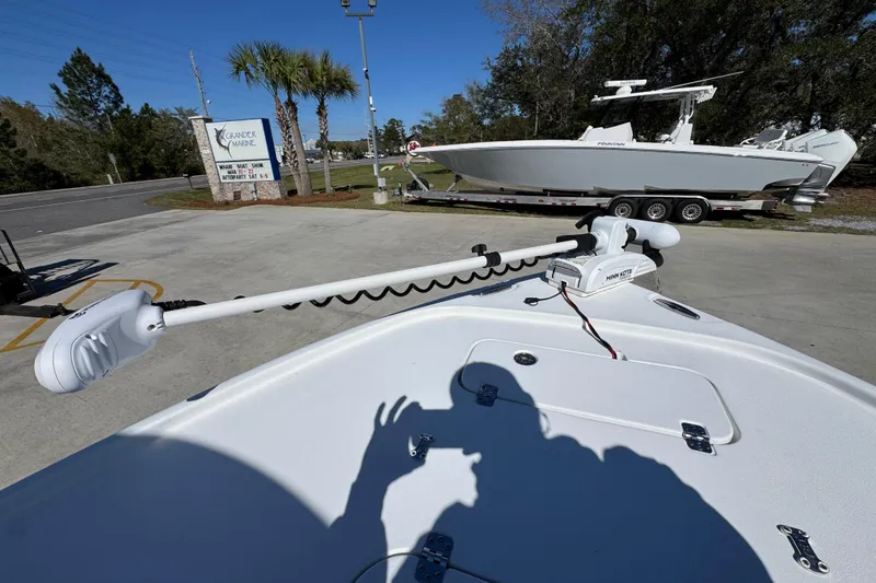 Slide: The Image of 2023 Sea Hunt BX 22 BR boat with trolling motor at a marine dealership. - 20