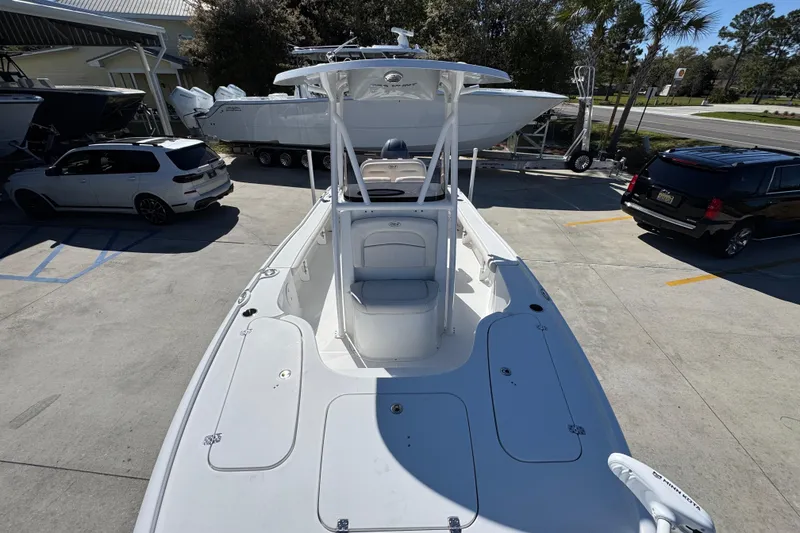 Slide: The Image of 2023 Sea Hunt BX 22 BR boat in parking lot, surrounded by vehicles. - 23