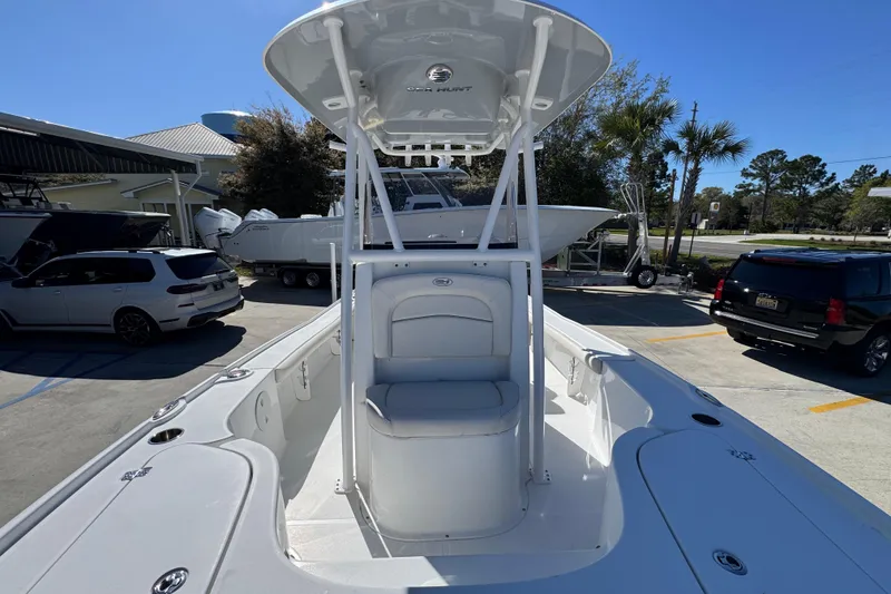 Slide: The Image of 2023 Sea Hunt BX 22 BR boat with T-top and seating, parked outdoors. - 24
