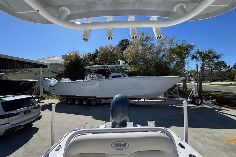 Slide: The Image of 2023 Sea Hunt BX 22 BR boat on trailer, parked outdoors under clear blue sky. - 28