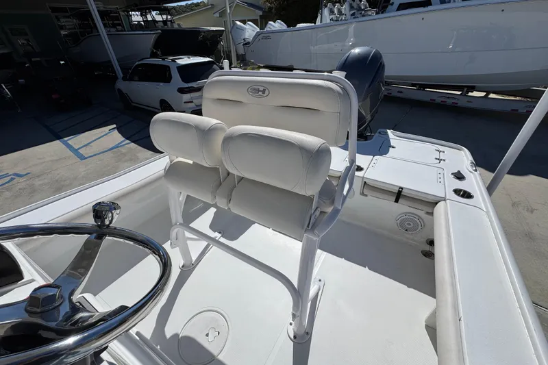 Slide: The Image of 2023 Sea Hunt BX 22 BR boat interior with white seating and steering wheel. - 30