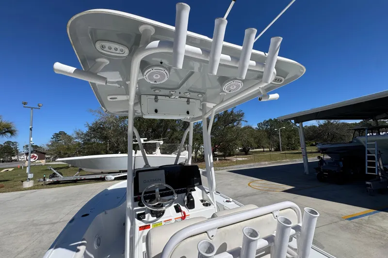 Slide: The Image of 2023 Sea Hunt BX 22 BR boat with T-top and rod holders in a sunny outdoor setting. - 36