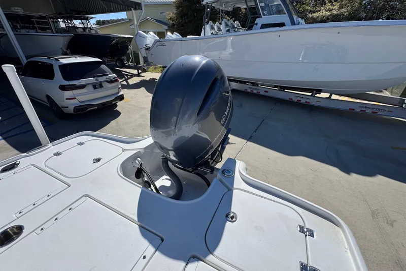 Slide: The Image of 2023 Sea Hunt BX 22 BR boat with Yamaha outboard motor in a marina setting. - 38