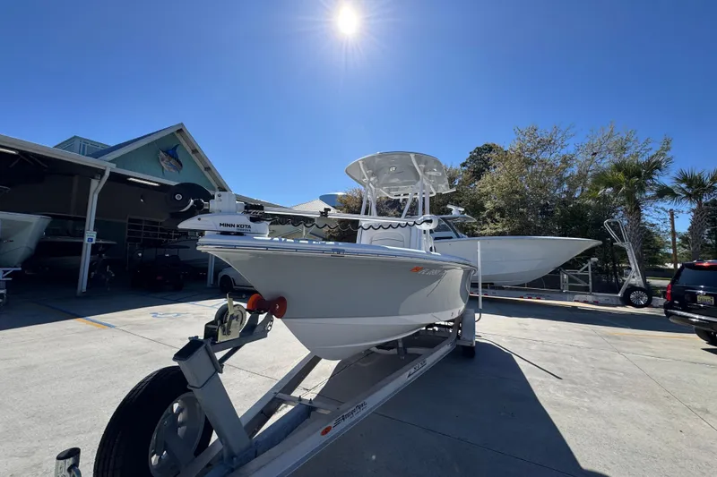 Slide: The Image of 2023 Sea Hunt BX 22 BR boat on trailer under sunny sky at marina. - 5