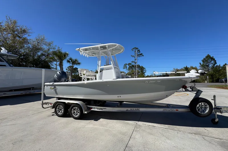 Slide: The Image of 2023 Sea Hunt BX 22 BR boat on trailer, parked outdoors under clear blue sky. - 9