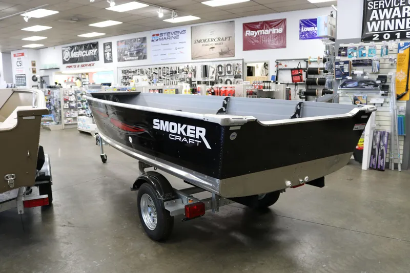 Slide: The Image of 2025 Smoker Craft Big Fisherman 14 boat displayed in a showroom. - 4