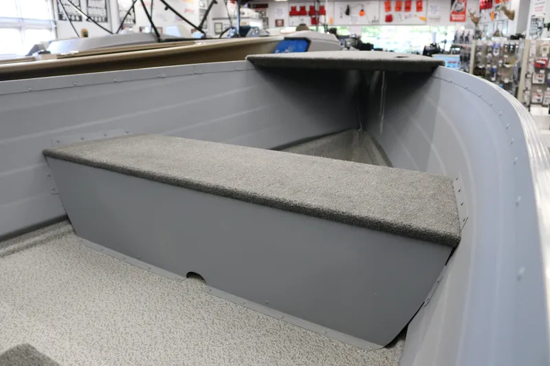 Slide: The Image of 2025 Smoker Craft Big Fisherman 14 interior with carpeted seating and storage. - 7