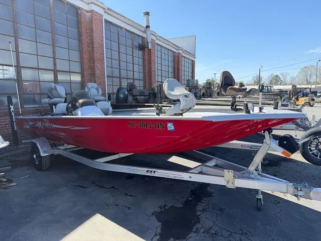 The Image of Red 2019 Xpress XP 200 Catfish boat on trailer outside warehouse. - 1