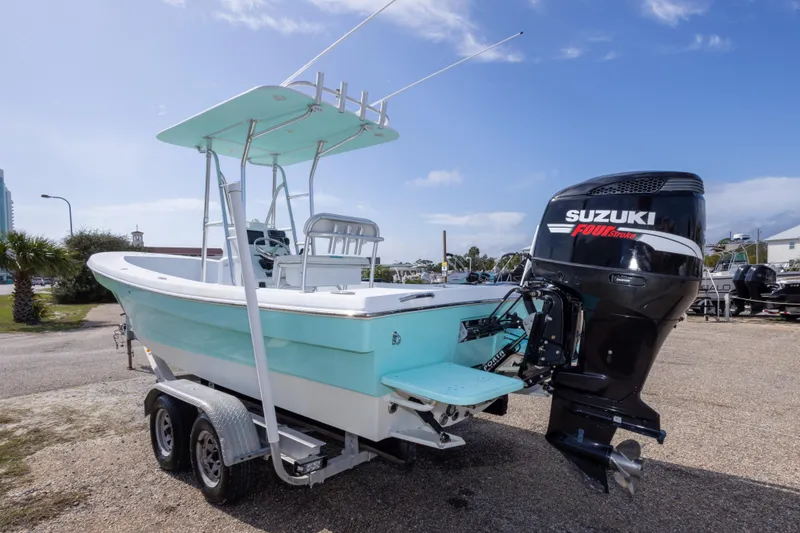 Slide: The Image of 2007 Andros Cuda 23 boat with Suzuki outboard motor on trailer, parked outdoors. - 10