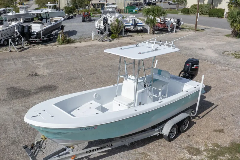 Slide: The Image of 2007 Andros Cuda 23 boat on trailer, parked in a marina lot. - 14