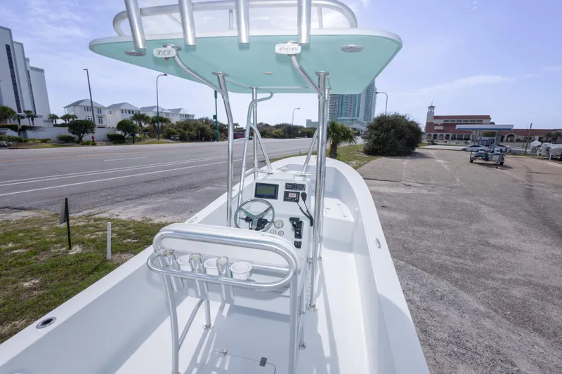 Slide: The Image of 2007 Andros Cuda 23 boat parked near a road, showcasing its helm and seating area. - 15
