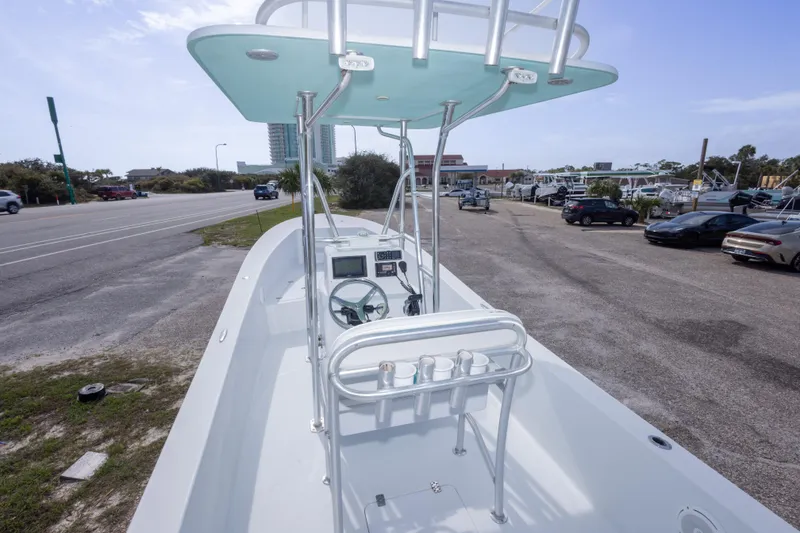Slide: The Image of 2007 Andros Cuda 23 boat with T-top, parked near a road and dealership. - 16