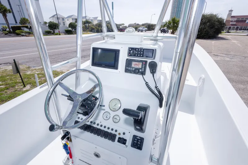 Slide: The Image of 2007 Andros Cuda 23 boat console with steering wheel, gauges, and navigation equipment. - 18