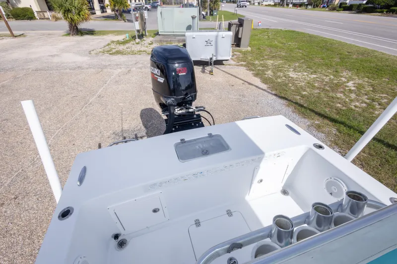 Slide: The Image of 2007 Andros Cuda 23 boat with Suzuki 225 outboard motor, parked on a driveway. - 21