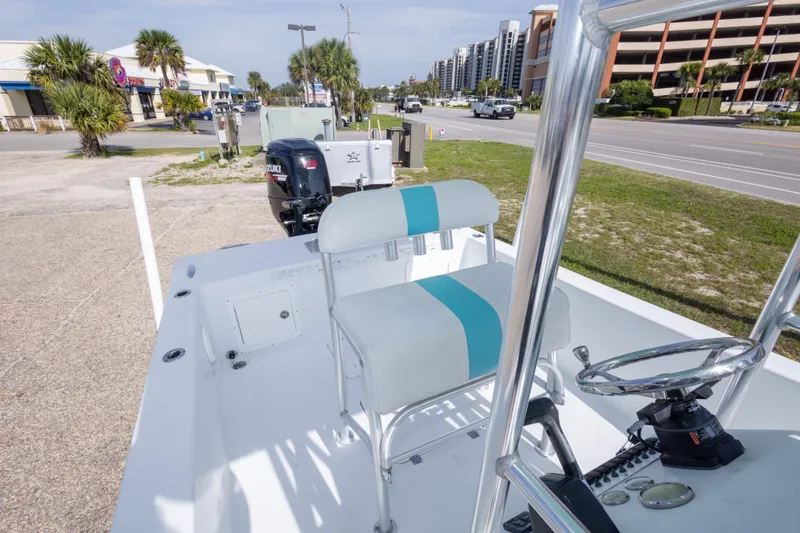 Slide: The Image of 2007 Andros Cuda 23 boat with Suzuki outboard motor, parked near a road. - 24