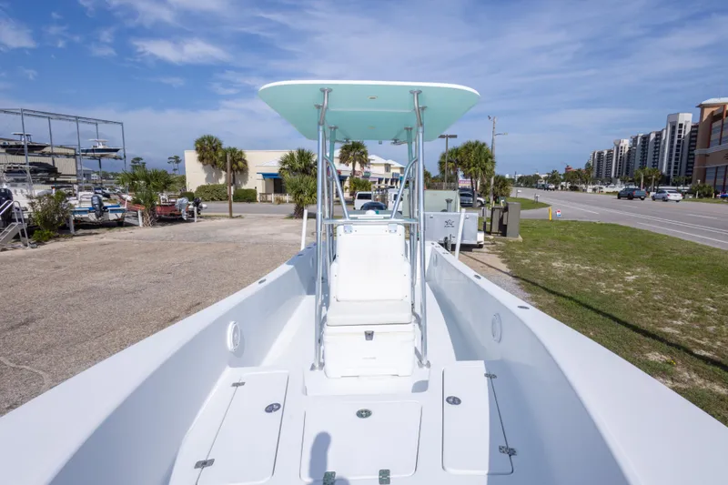 Slide: The Image of 2007 Andros Cuda 23 boat with center console, parked near a road and buildings. - 26