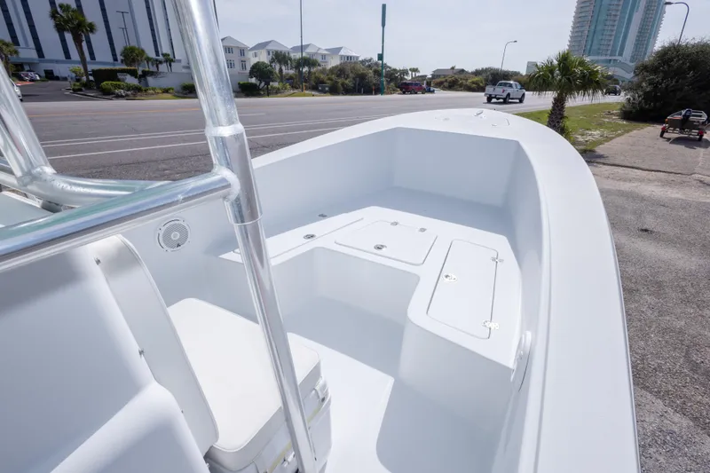 Slide: The Image of 2007 Andros Cuda 23 boat interior with storage compartments, parked near a road. - 27