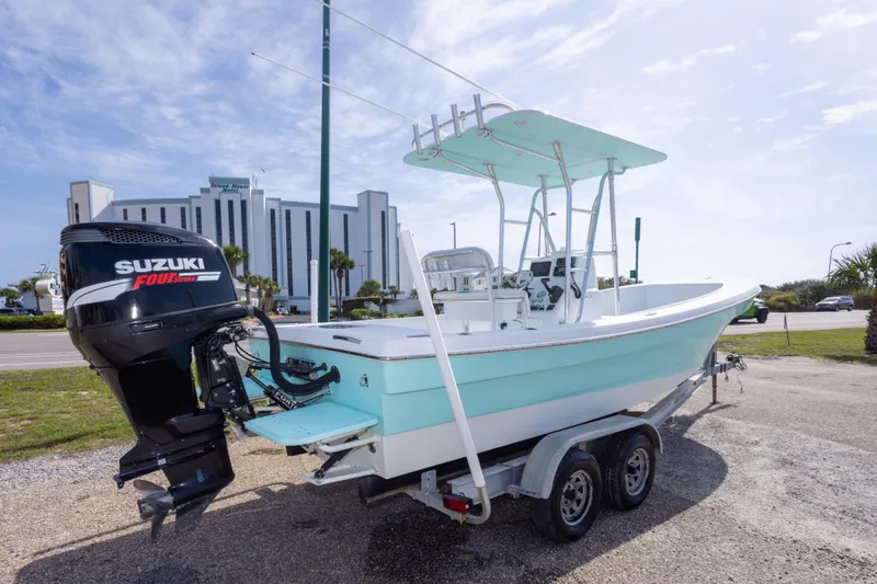 Slide: The Image of 2007 Andros Cuda 23 boat with Suzuki Four Stroke engine on trailer, near a hotel. - 3