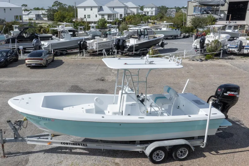 Slide: The Image of 2007 Andros Cuda 23 boat on trailer, parked in a marina with other boats. - 9