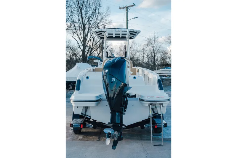 Slide: The Image of 2023 Bayliner Trophy T24CC boat with powerful outboard motor, parked outdoors. - 3