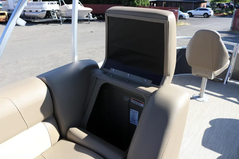 Slide: The Image of 2025 SunChaser Vista 18 Fish boat interior with beige seating and storage compartment. - 10