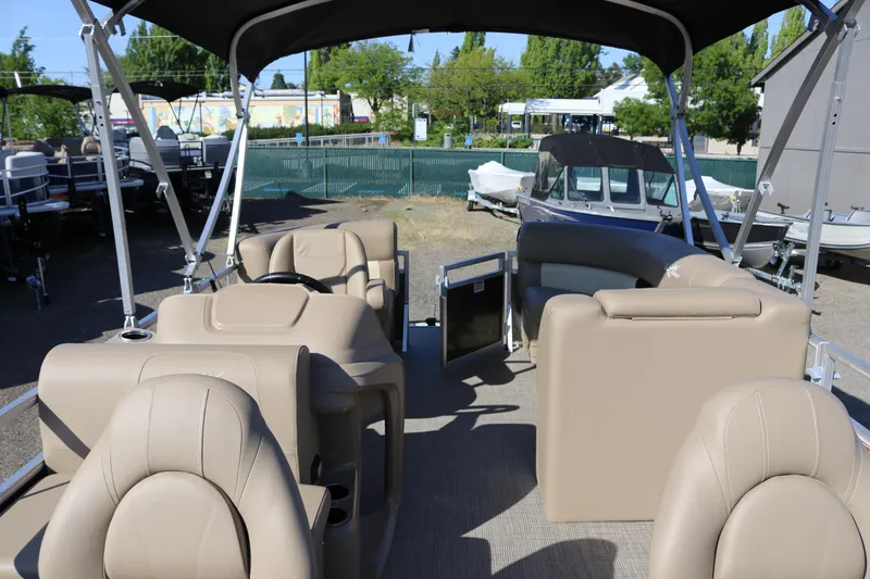 Slide: The Image of 2025 SunChaser Vista 18 Fish pontoon boat interior with beige seating and canopy. - 6