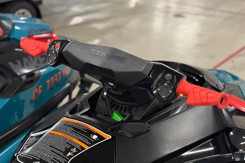 Slide: The Image of 2018 Sea-Doo Wake Pro 230 handlebars with red grips and control buttons. - 10