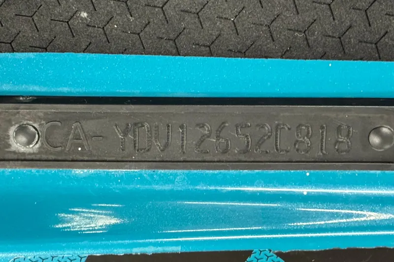 Slide: The Image of 2018 Sea-Doo Wake Pro 230 hull identification number on blue surface. - 14