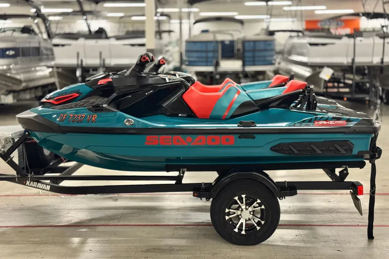 Slide: The Image of 2018 Sea-Doo Wake Pro 230 jet ski on trailer in showroom. - 16