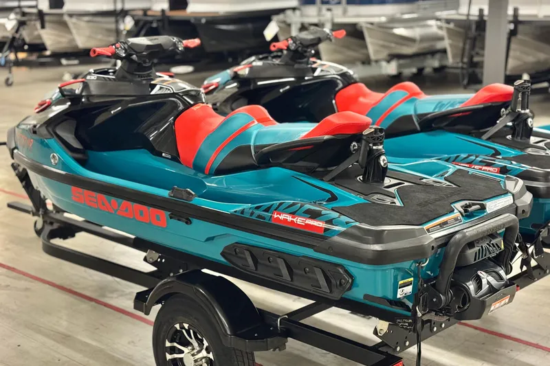 Slide: The Image of 2018 Sea-Doo Wake Pro 230 jet skis on trailer, vibrant teal and red design. - 17